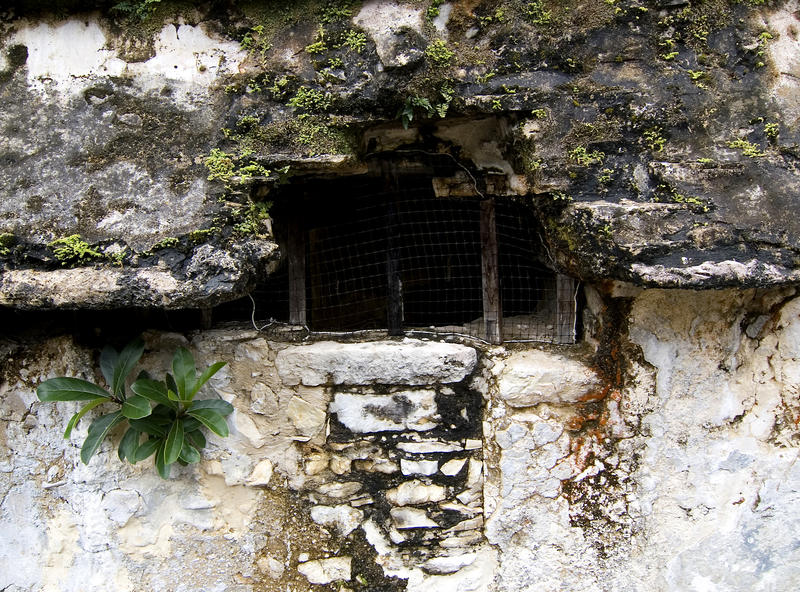 a smalll grated window into a prison cell